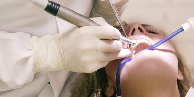 A woman having a dental implant procedure by a general dentist